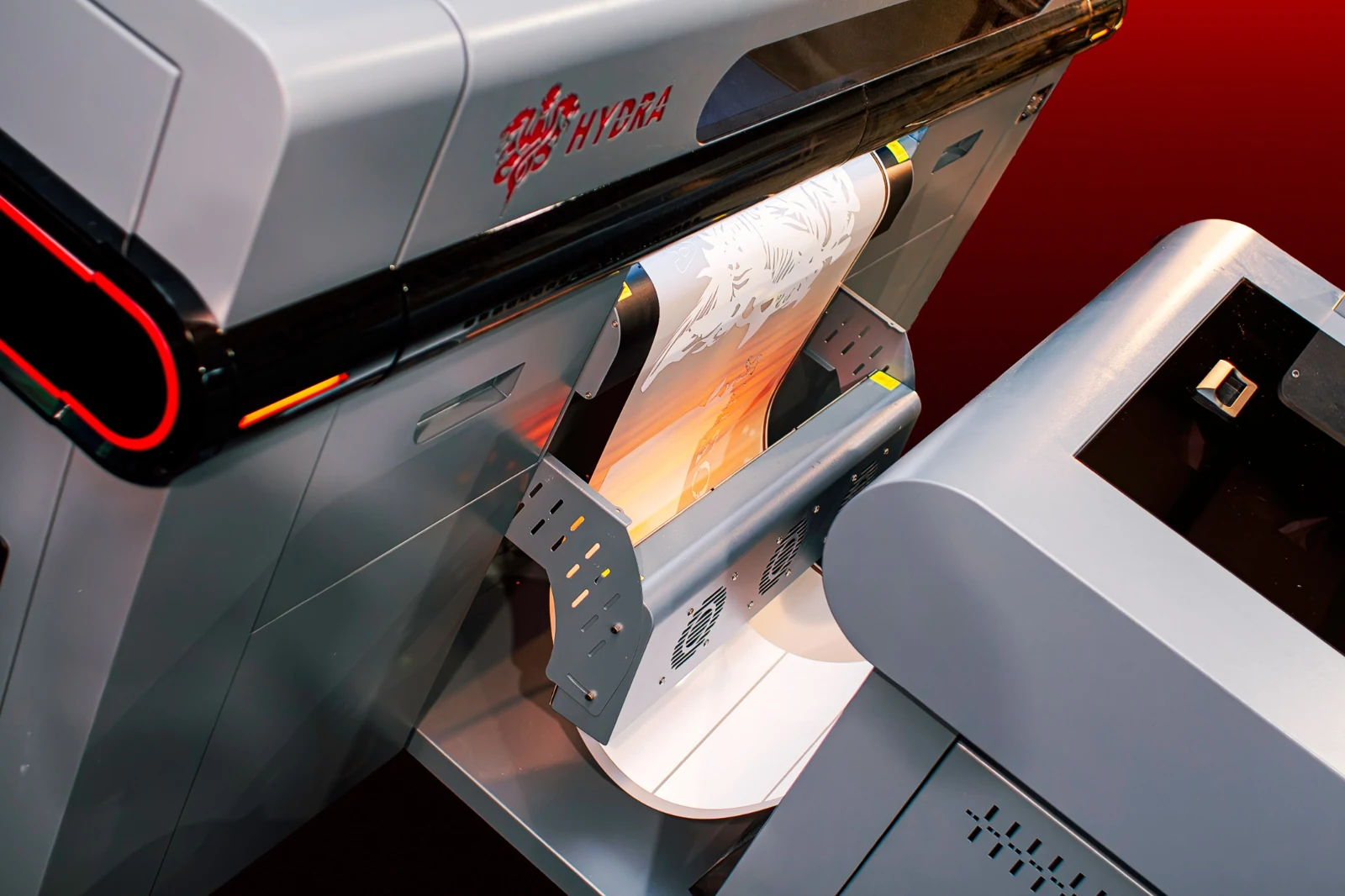 Printed transfer film emerging from the Super Hydra and entering the finishing system